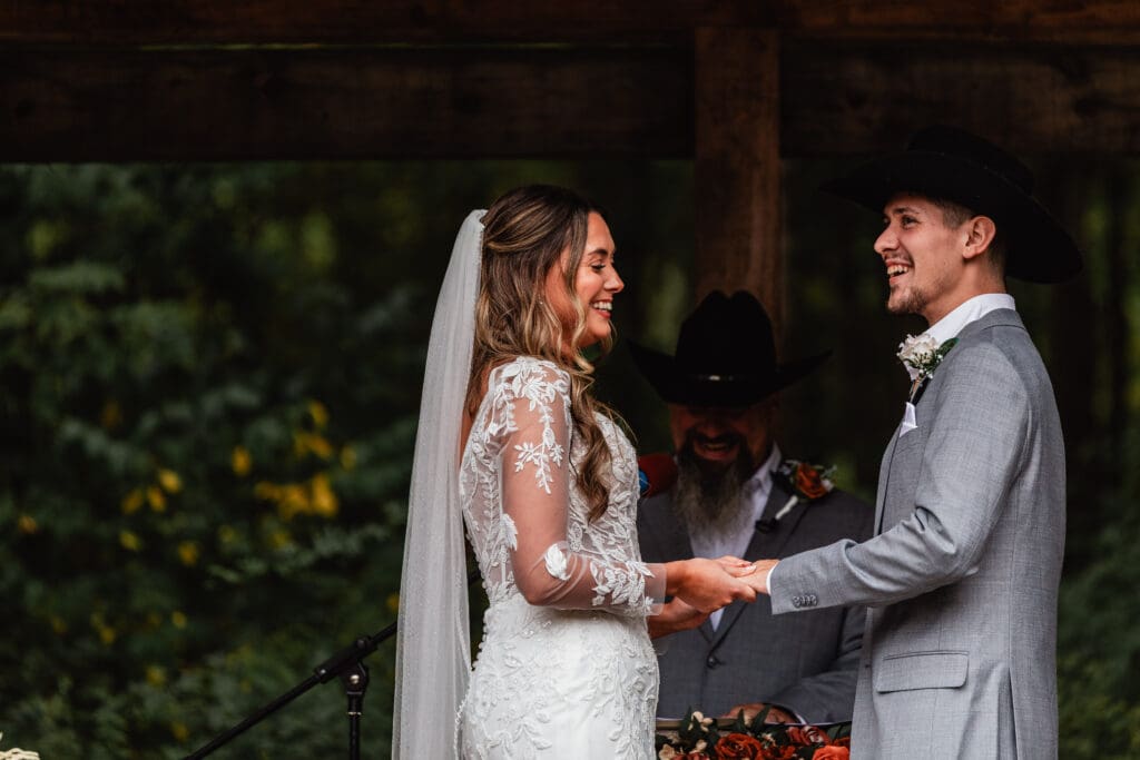 Bride and groom laughing together during their wedding ceremony at Hinckston Run Farm