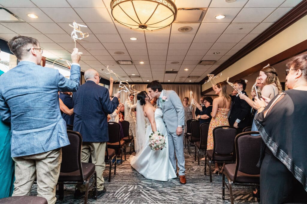 Wedding couple dips and kisses during their ceremony at Sheraton Station Square