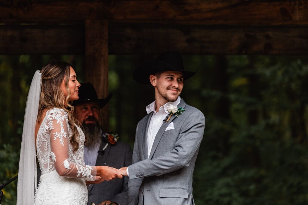 Bride and groom sharing joyful moments during outdoor wedding ceremony at Hinckston Run Farm