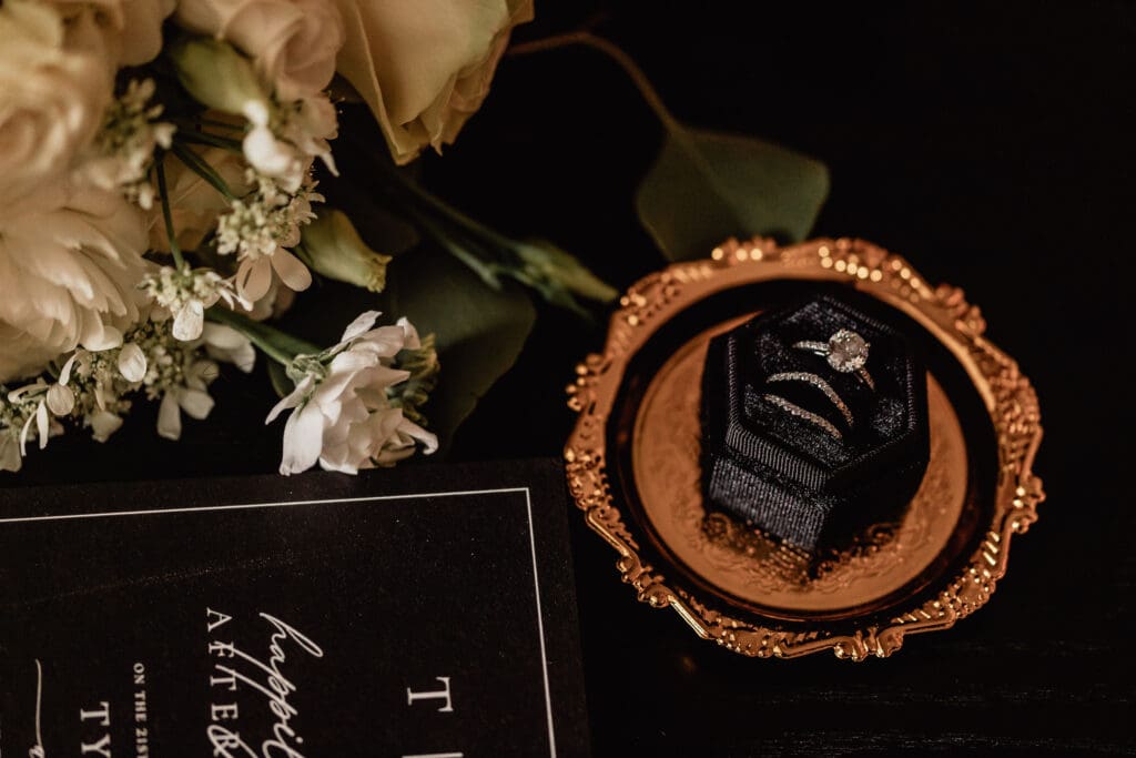 Close-up of wedding invitation, rings, and details from an Allegheny County Courthouse wedding
