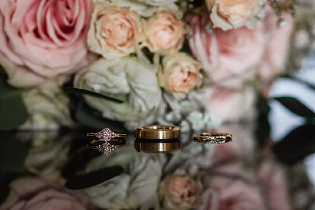 Engagement rings and wedding bands styled on pink roses at Sheraton Station Square