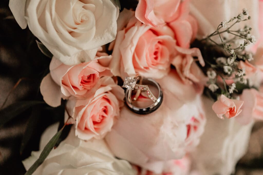 Close-up of bride and groom’s wedding bands resting in the bride’s floral bouquet at a Phipps Botanical Gardens wedding in Pittsburgh