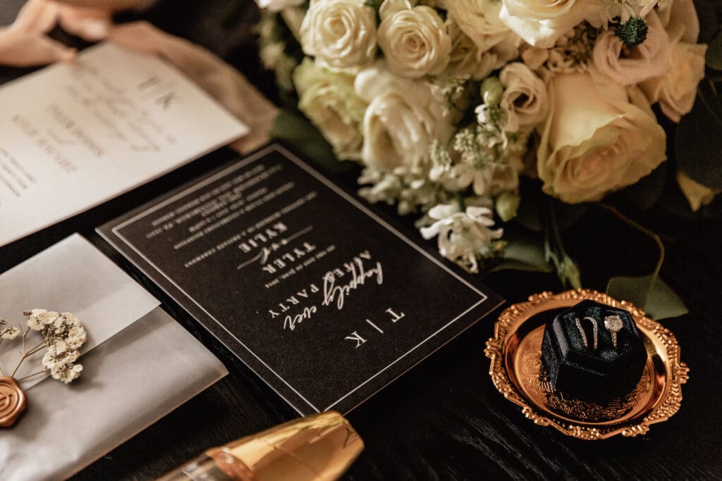Close-up of wedding invitation, rings, and flowers from an Allegheny County Courthouse wedding