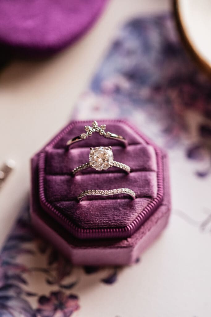 Close up of wedding bands inside a purple ring box at Pittsburgh Airport Marriott wedding