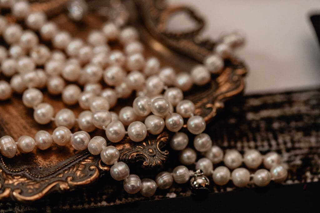 Delicate wedding flat lay with vintage pearls on gold tray styled for a Lingrow Farm wedding