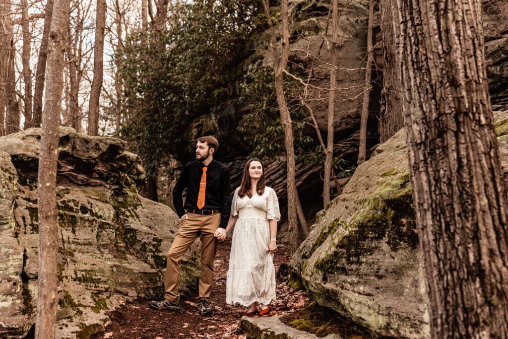 Couple holding hands while gazing out in different directions at Coopers Rock State Park overlook