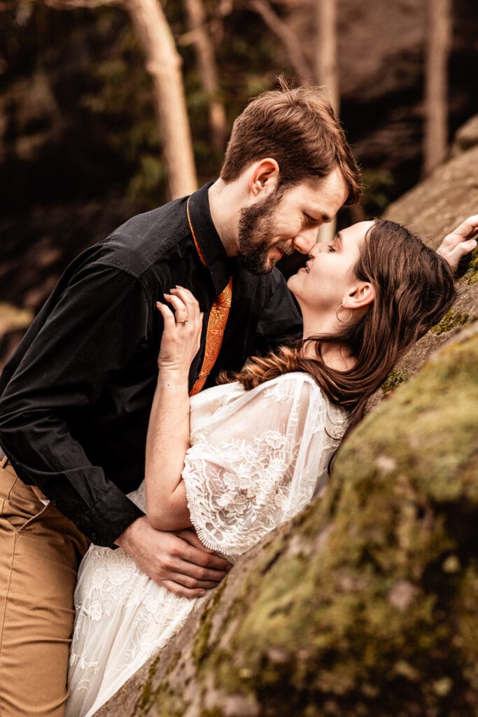 Couple sharing a quiet moment against a rock formation at Coopers Rock State Park