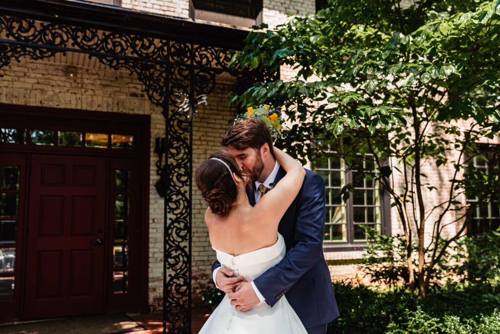 Newlyweds embracing during garden first look at Succop Nature Park wedding