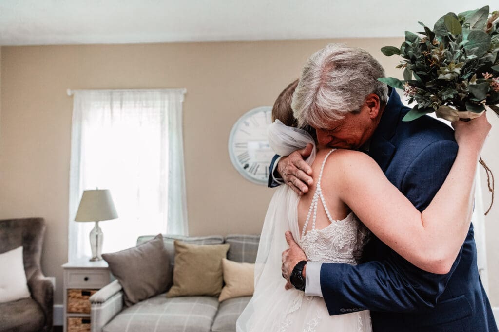 Emotional first look between bride and her father in the bridal suite at The Barn at Ever Thine in Butler County, Pennsylvania