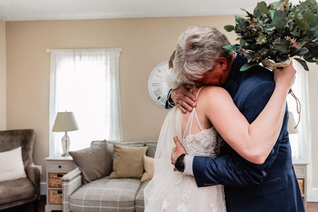 Father and bride embracing before the ceremony at The Barn at Ever Thine in Fenelton, PA