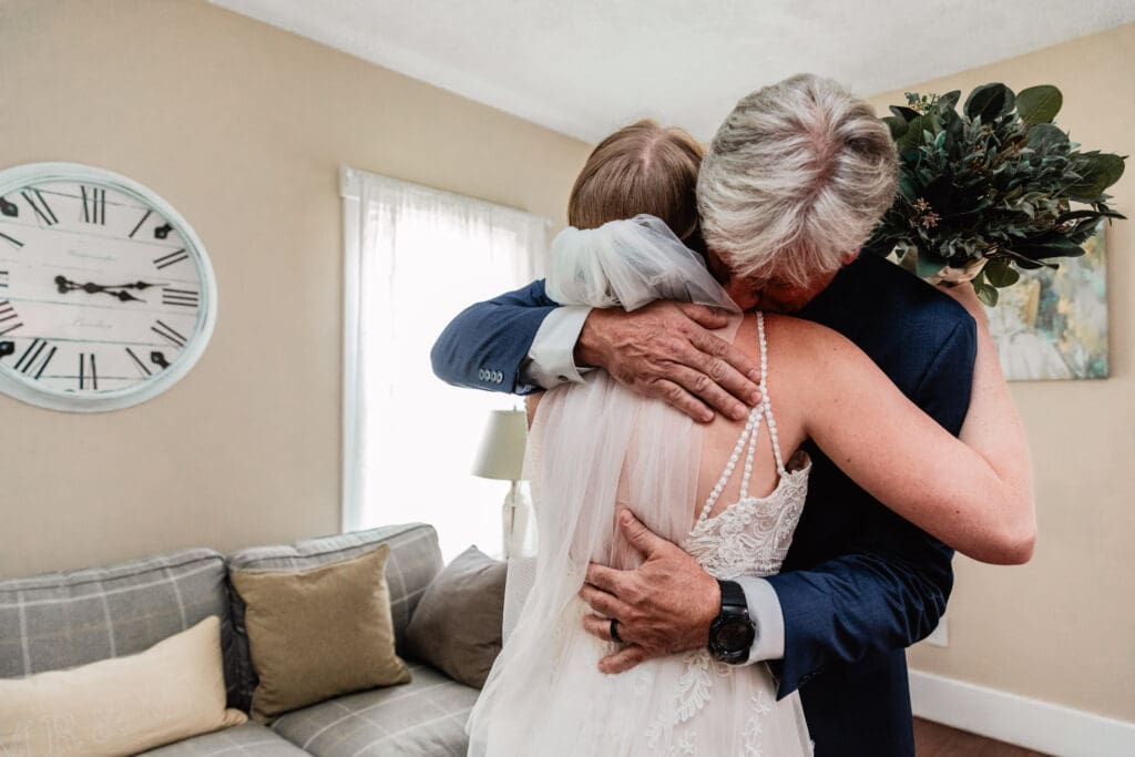 Bride sharing a quiet hug with her father in the bridal suite at The Barn at Ever Thine in Butler County, PA