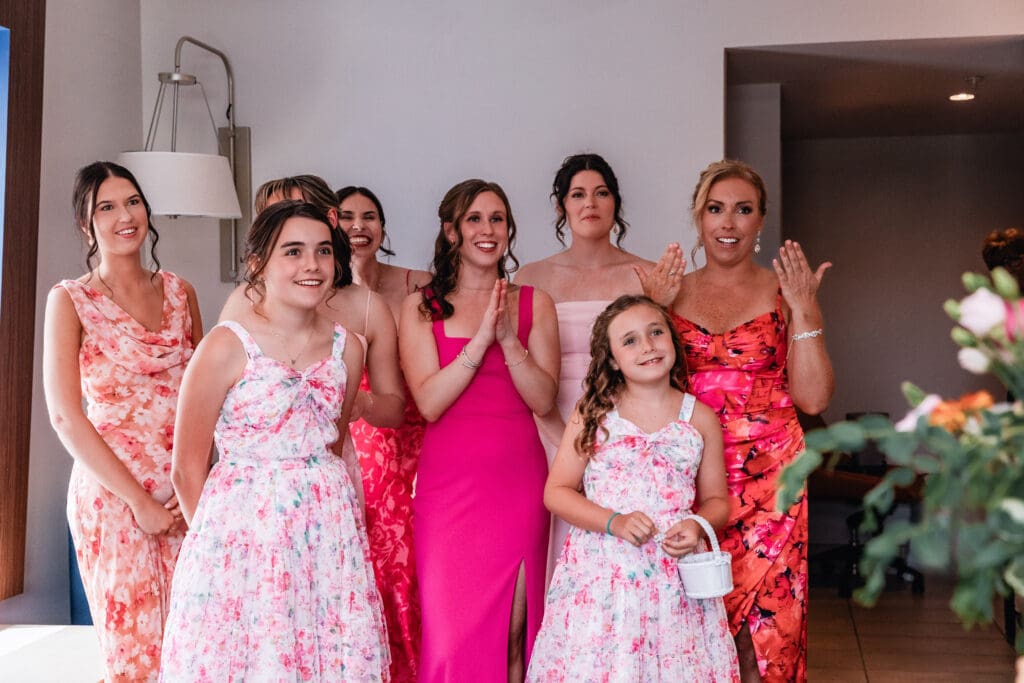 Bridesmaids reacting emotionally during first look with bride at the National Aviary