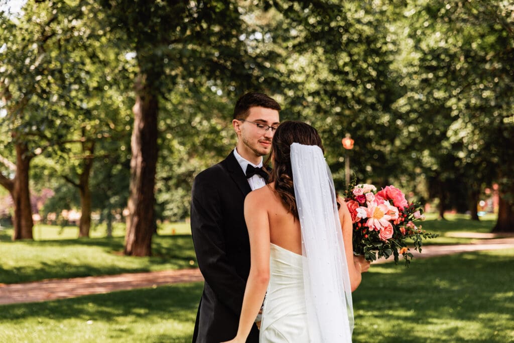 Emotional first look moment between bride and groom at the National Aviary