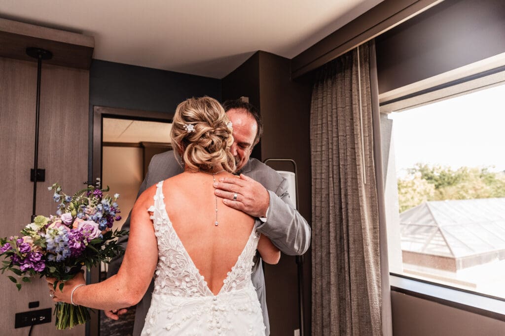Pittsburgh bride and step-father share an emotional embrace after first look