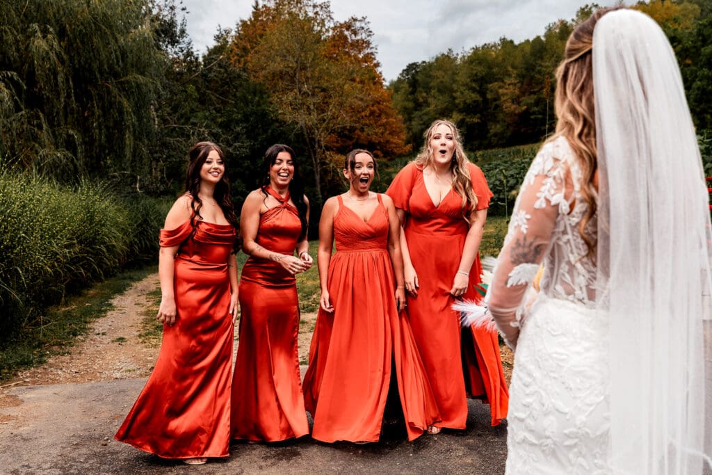 Bridesmaids laughing during first look with bride at Hinckston Run Farm wedding