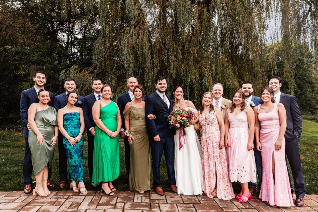 Bride and groom posing with family during formal wedding portraits at Willowbrook in Volant, Pennsylvania