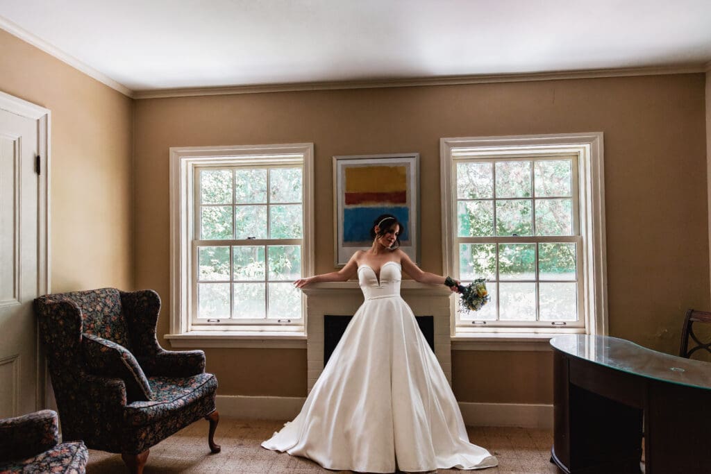Bride posing in front of mantel during wedding photo session at Succop Nature Park