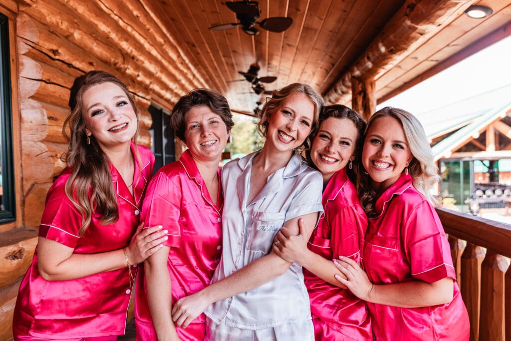 Pittsburgh bride and bridesmaids hugging and smiling in bridal suite at The Gathering Place at Darlington Lake