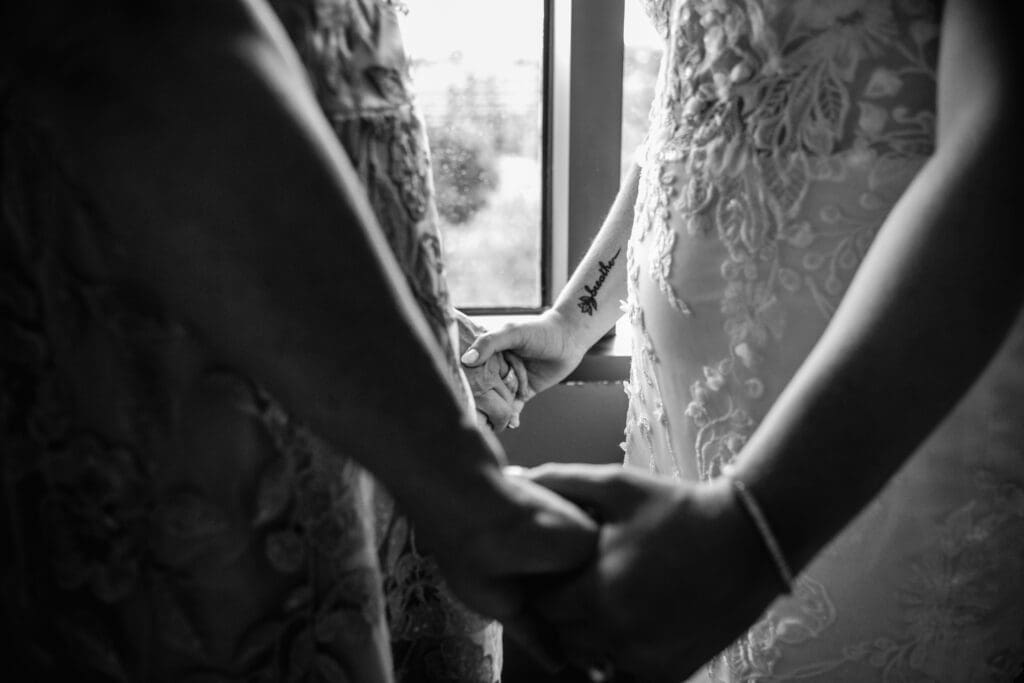 Close up of bride’s hands and tattoos with mother of the bride helping during Pittsburgh wedding