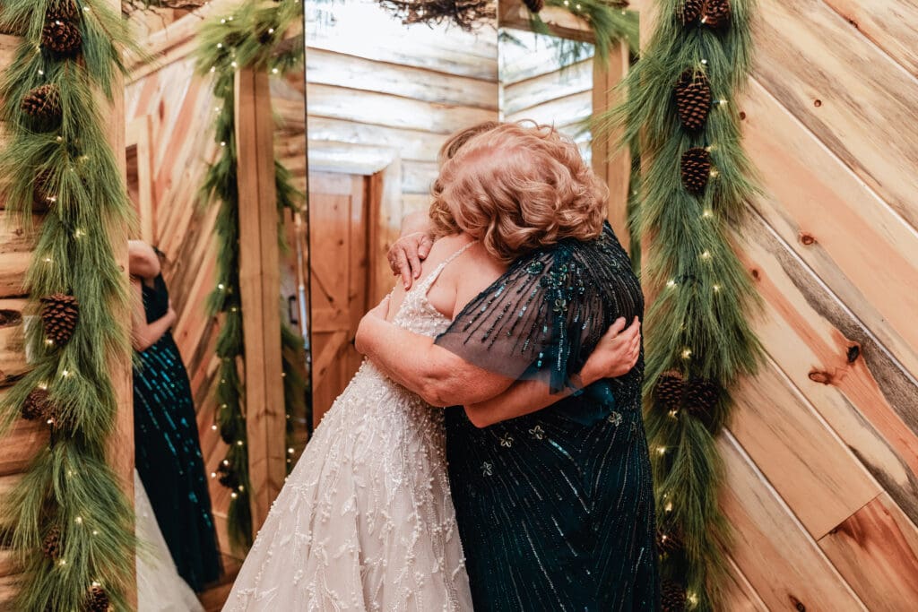 Bride and her mother sharing an emotional hug in bridal suite at The Gathering Place at Darlington Lake