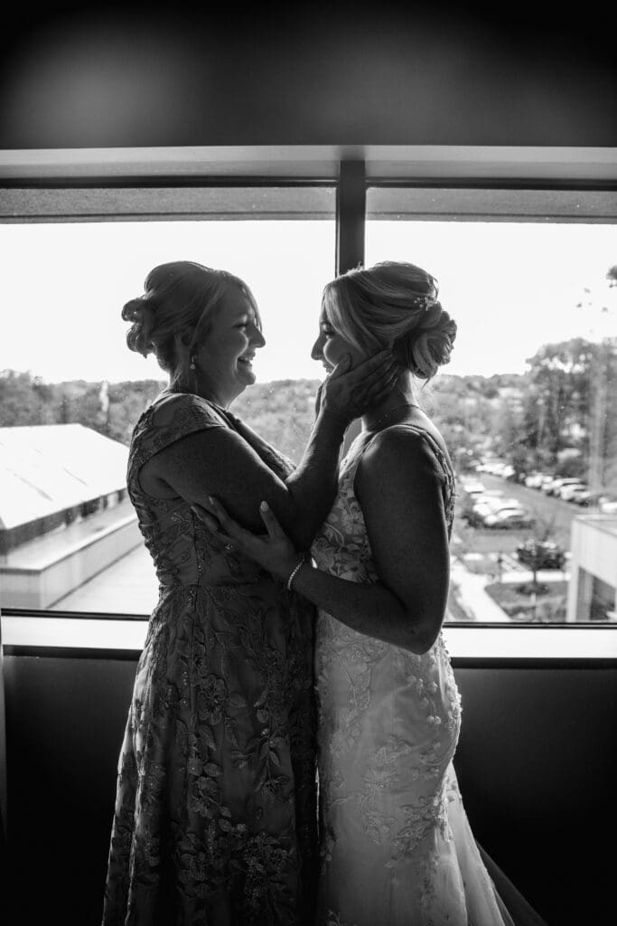 Pittsburgh bride and her mother share an emotional embrace before ceremony at Pittsburgh Airport Marriott