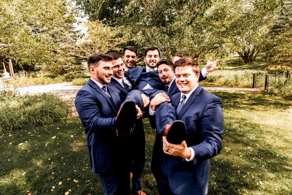 Groomsmen lift and celebrate the groom during a Willowbrook wedding in Volant, PA