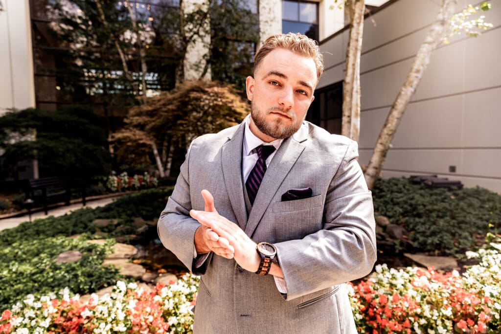 Pittsburgh groom rubbing his hands and staring at camera during portraits