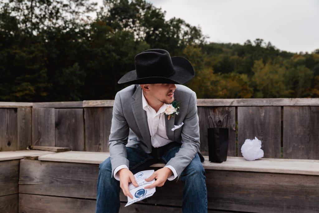 Groom opening emotional wedding gifts from bride at Hinckston Run Farm
