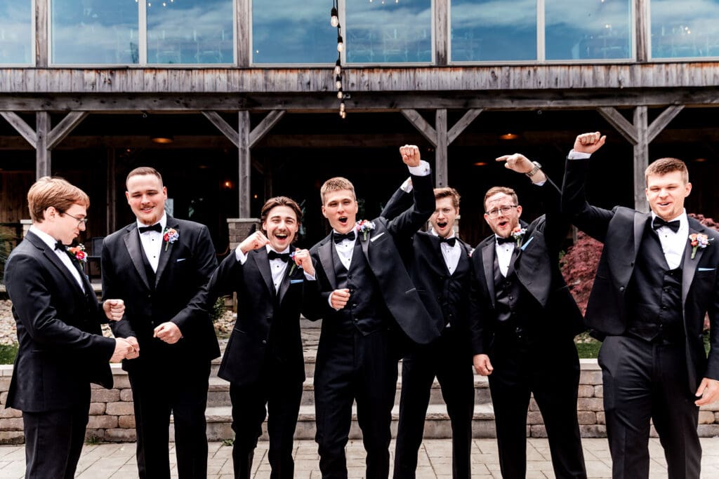Groomsmen laugh together outside during a Willowbrook wedding