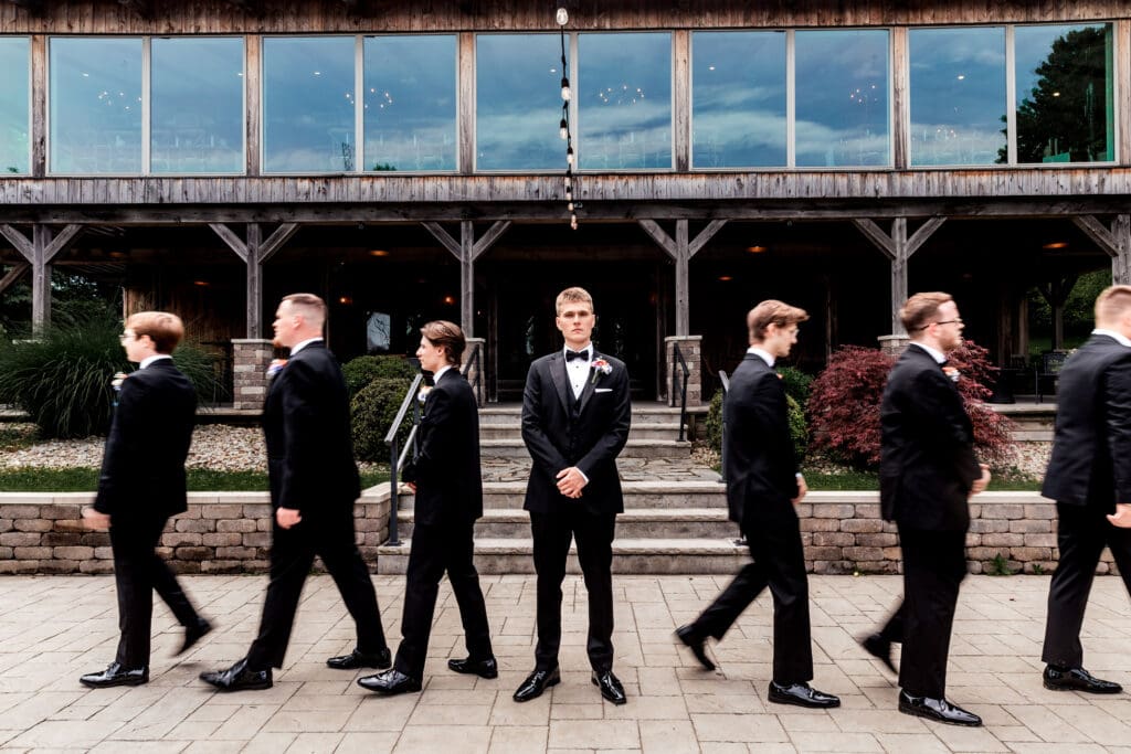 Groomsmen line up outside the Willowbrook wedding venue