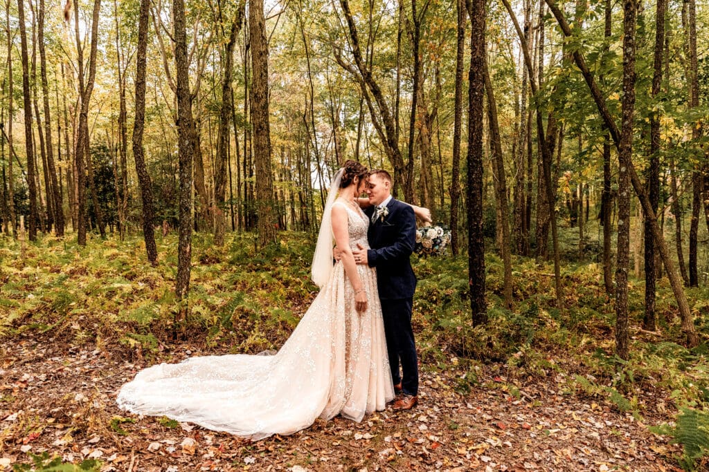Wedding couple embracing in a lush fern field at Pinehall at Eisler Farm