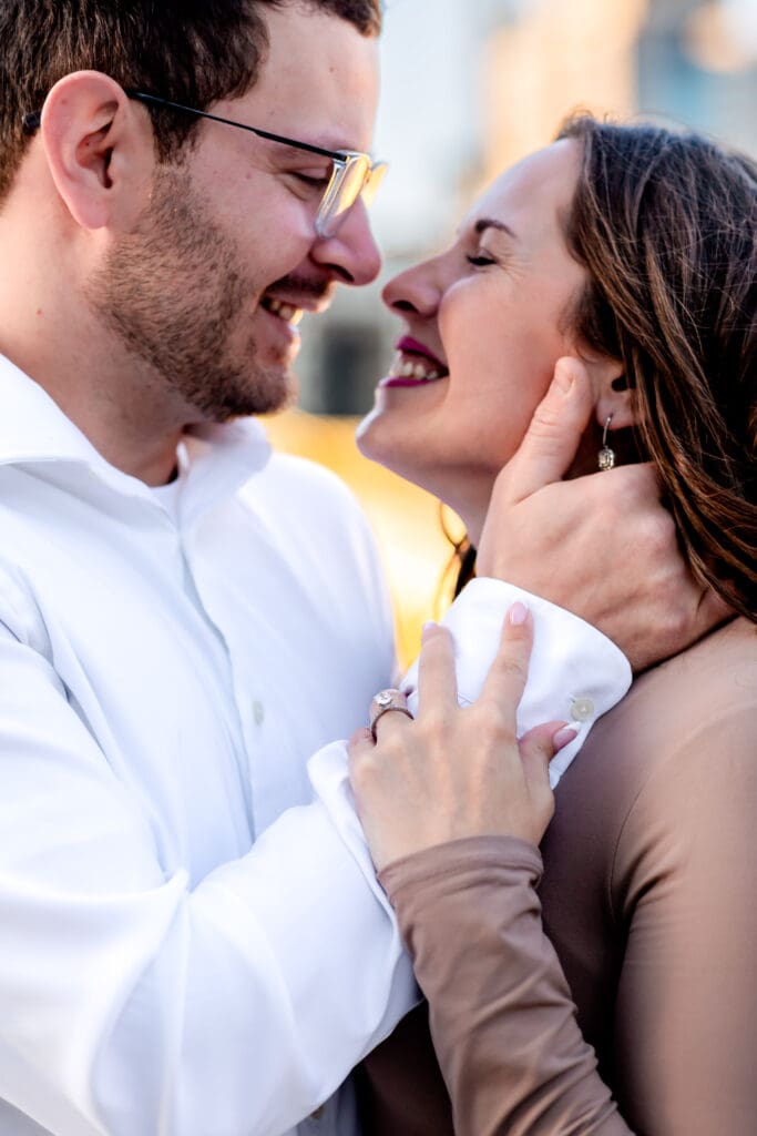 Romantic couple dressed in white and brown share tender, intimate close-up moments during a Pittsburgh engagement photography session