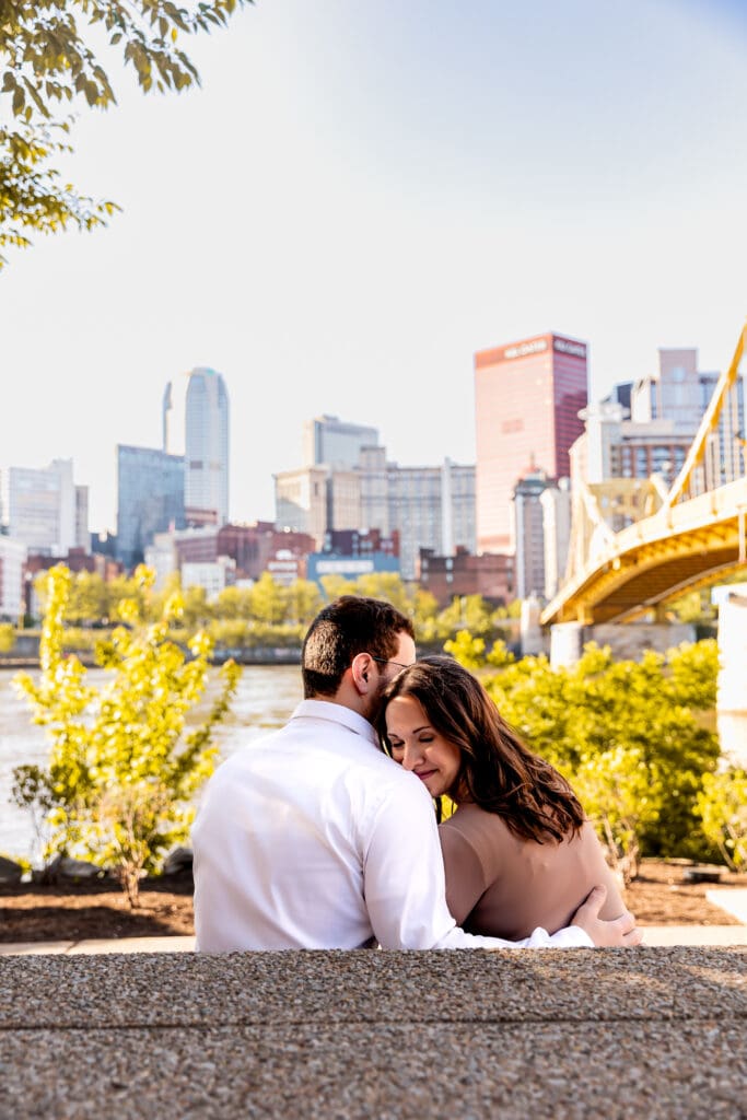 Close-up romantic portrait of a couple sharing an intimate moment with soft lighting and white attire during an Pittsburgh engagement session