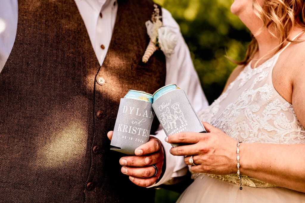 Close-up of custom wedding coozies featuring the couple’s dogs at a family farm wedding in Monongahela, PA