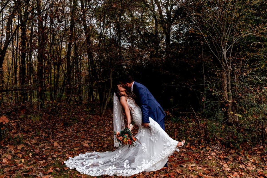 Romantic outdoor wedding photos in autumn woods at Hinckston Run Farm