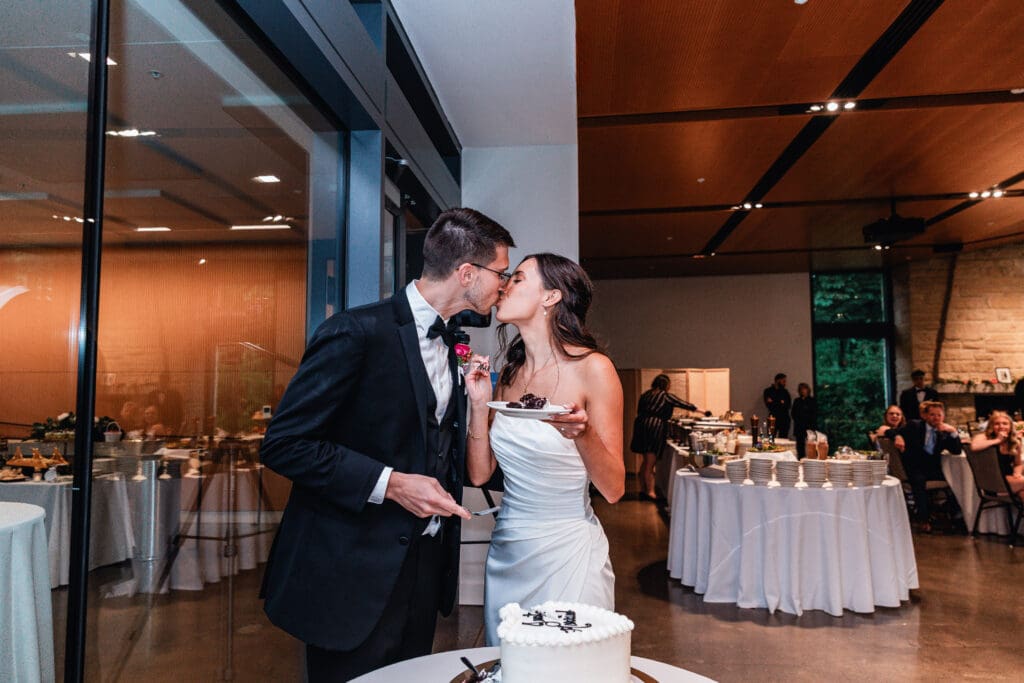 Bride and groom cutting white heart-shaped wedding cake at elegant National Aviary reception