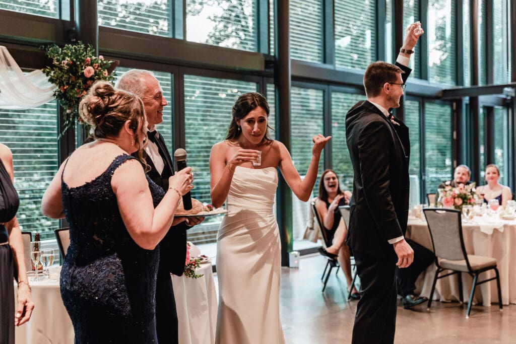 Bride taking a celebratory shot as part of Polish wedding tradition at the National Aviary reception