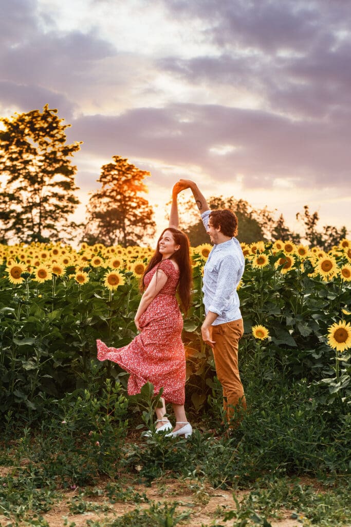 Pittsburgh couple laughing and connecting during a sunset engagement session at Schwirian Sunflower Farm
