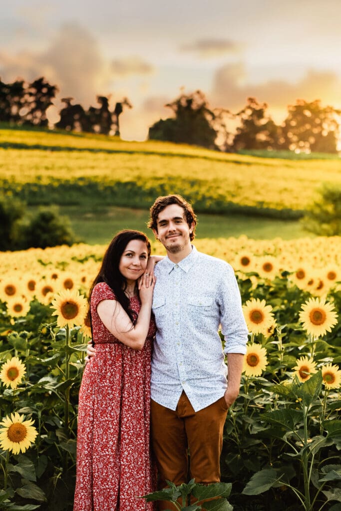 Golden hour engagement session at Schwirian Sunflower Farm with a Pittsburgh couple surrounded by blooming sunflowers at sunset