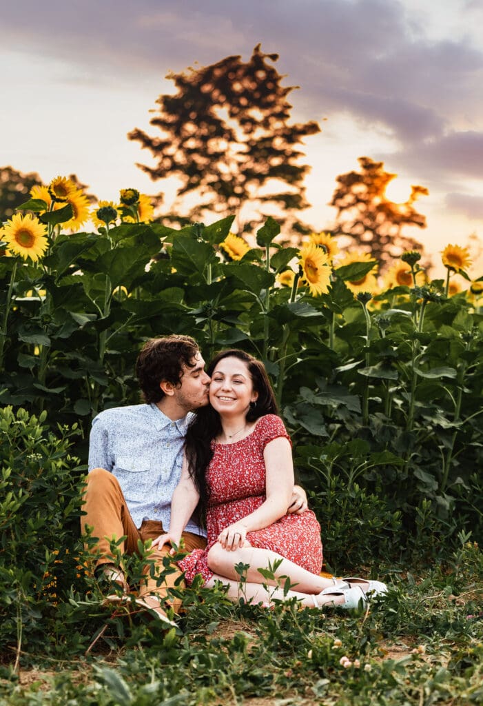 Engaged Pittsburgh couple sharing a quiet moment in a sunflower field at Schwirian Sunflower Festival at sunset