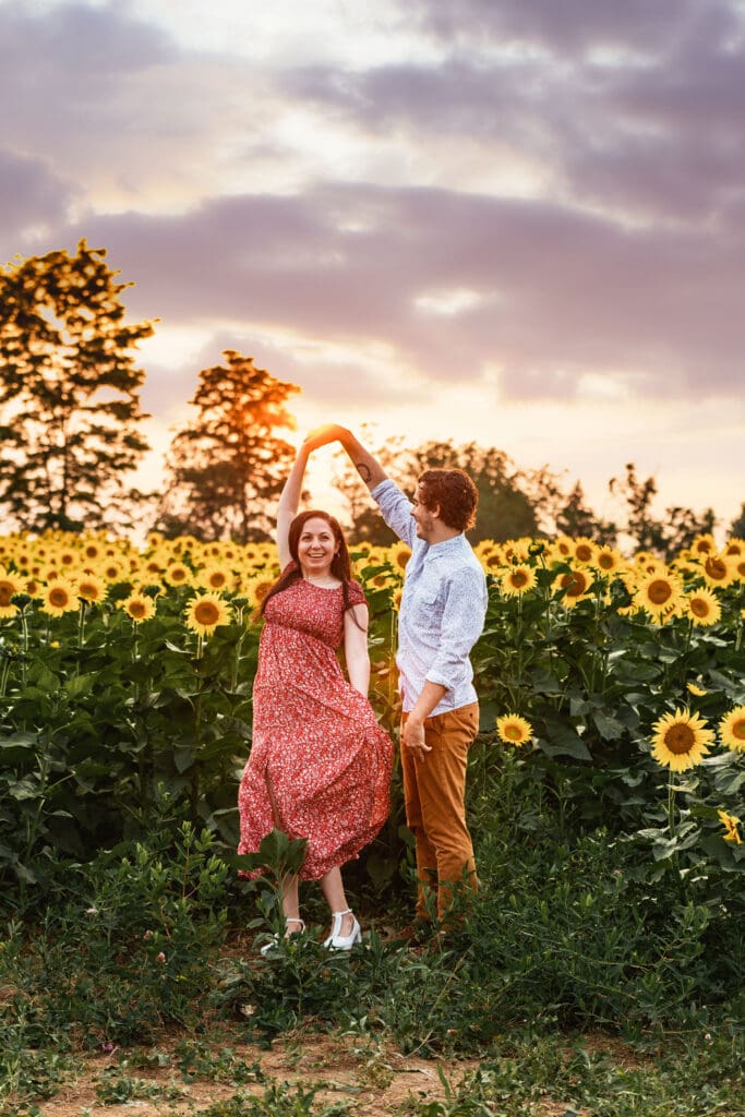 Pittsburgh engagement session capturing natural connection in a sunflower field at Schwirian Sunflower Farm during sunset