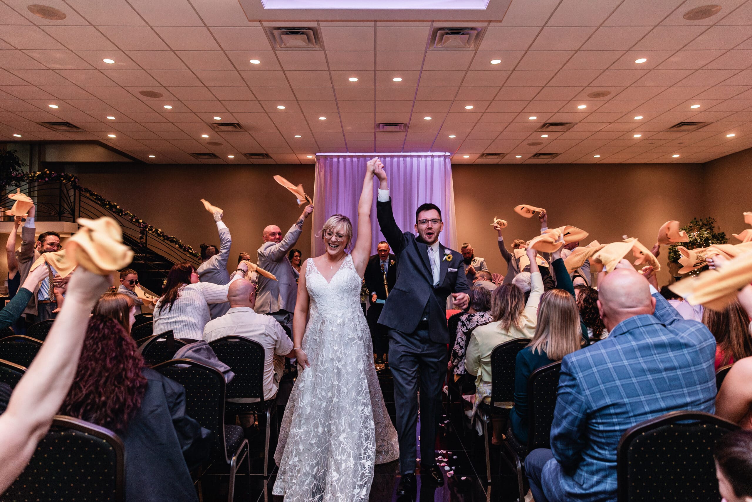 Wedding guests form a tunnel as the couple dances through during their reception at The Fez