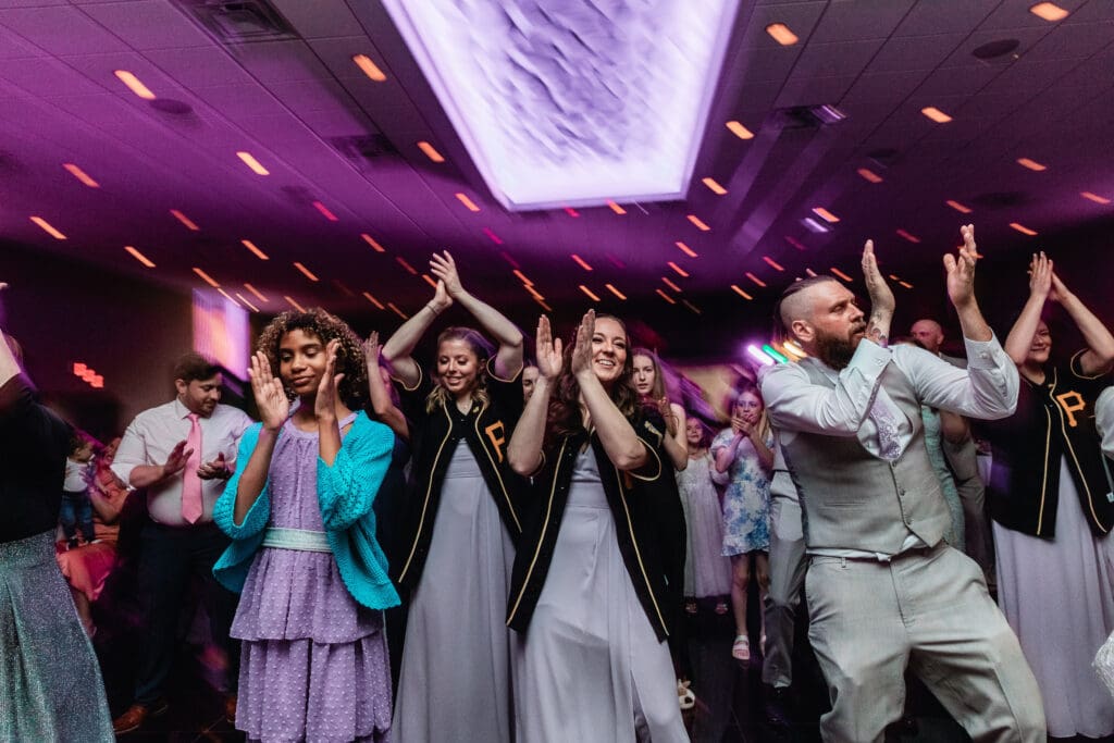 Wedding guests dancing enthusiastically at a reception at The Fez