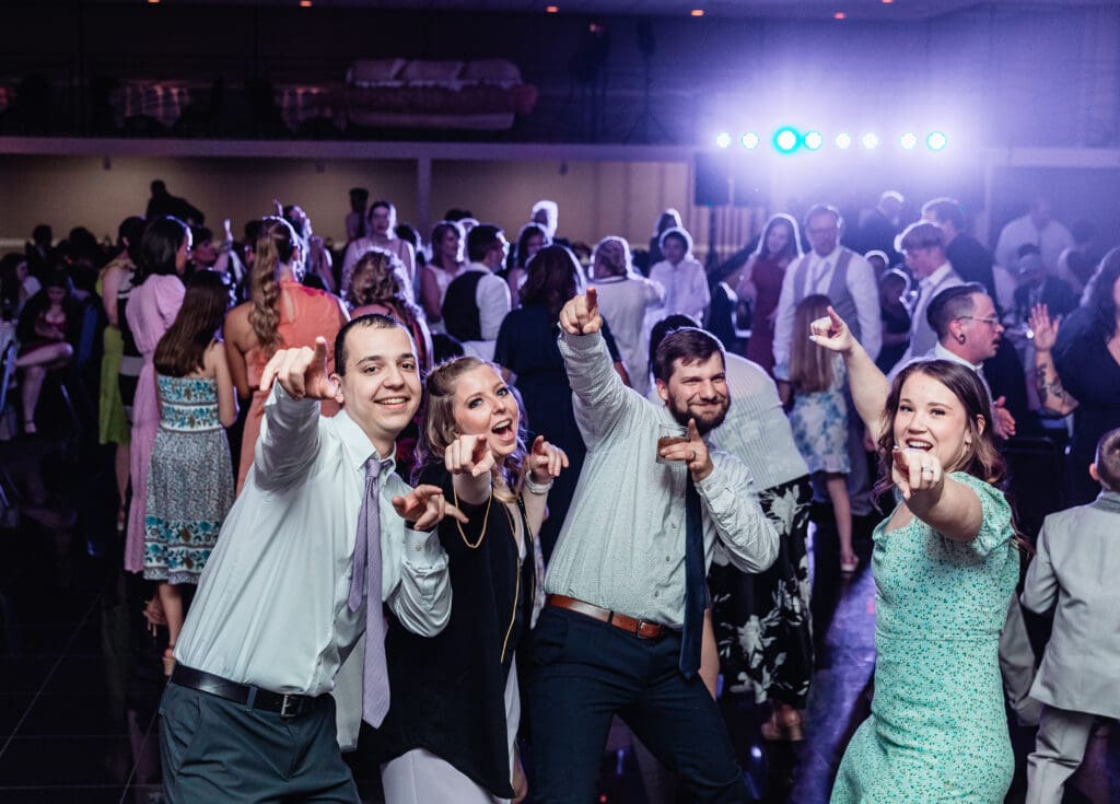 Wedding guests dancing and singing together during reception at The Fez
