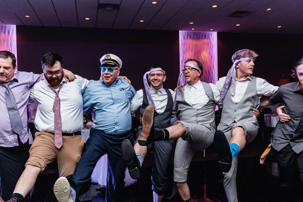 Wedding guests line up showing fun socks during reception at The Fez