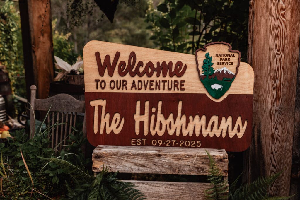 National Park themed welcome sign displayed at the outdoor ceremony entrance at Hinckston Run Farm
