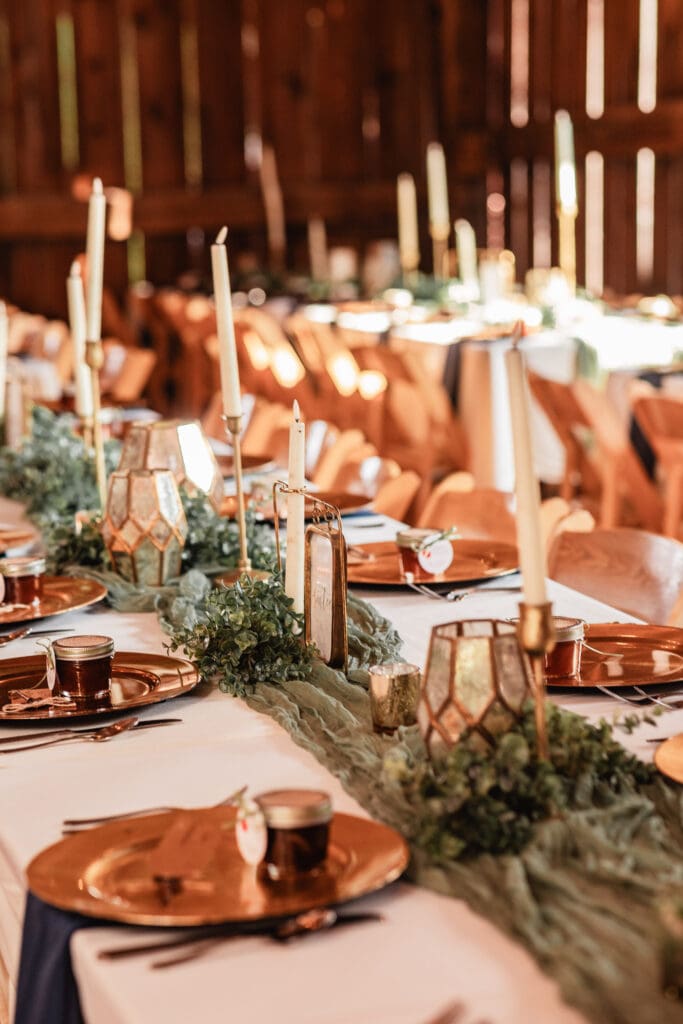 Photo of sage green runner, table number, and candlestick centerpiece at Pinehall at Eisler Farm fall wedding