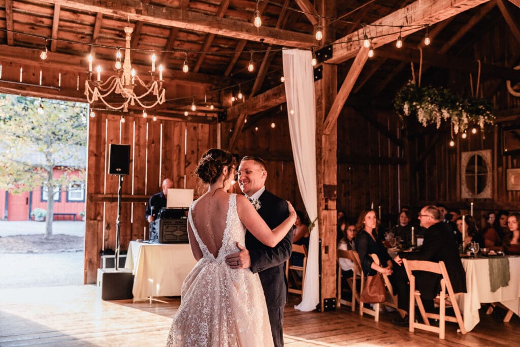 Bride and groom sharing first dance at Pinehall at Eisler Farm fall wedding reception