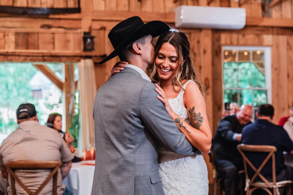 Couple sharing a romantic dance inside rustic barn at Hinckston Run Farm wedding