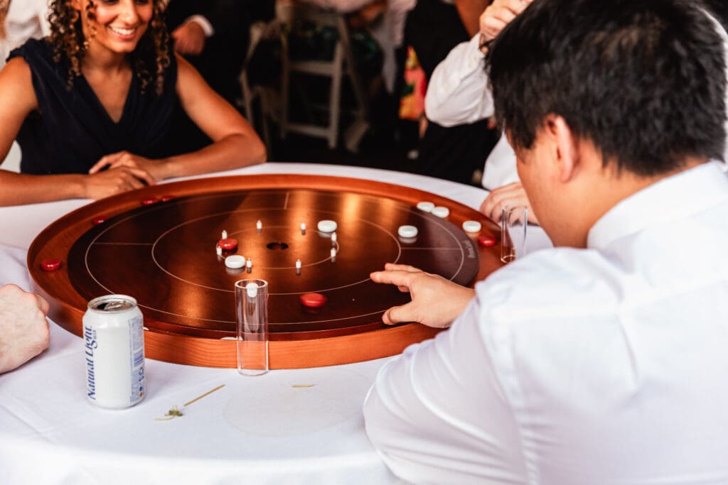 Guests playing crokinole at Succop Nature Park wedding